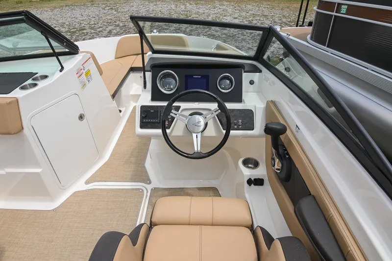 Slide: The Image of 2018 Sea Ray SPX 210 Outboard boat interior with steering wheel and dashboard controls. - 24