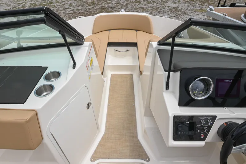 Slide: The Image of 2018 Sea Ray SPX 210 Outboard boat interior with beige seating and modern dashboard controls. - 29