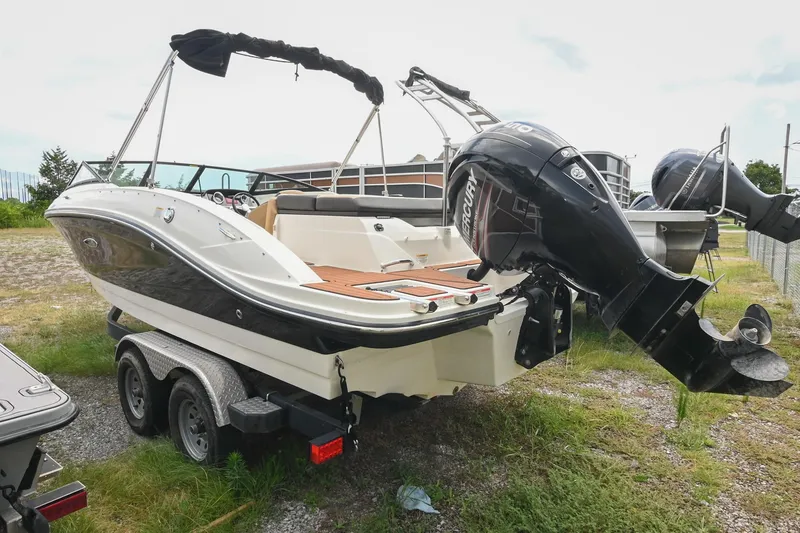 Slide: The Image of 2018 Sea Ray SPX 210 Outboard boat on trailer, featuring Mercury engine, parked outdoors. - 3