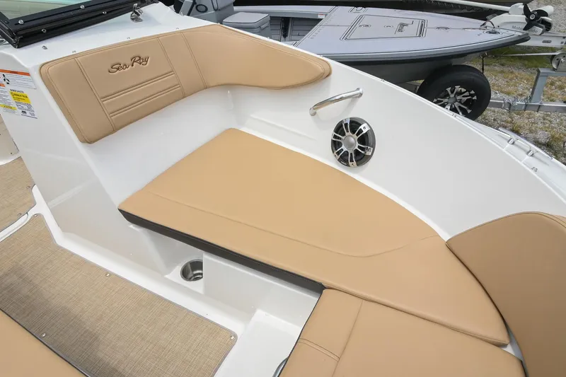 Slide: The Image of 2018 Sea Ray SPX 210 Outboard boat interior with tan seating and speaker. - 31
