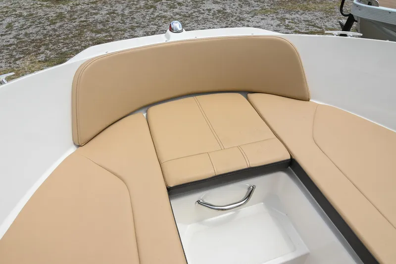 Slide: The Image of 2018 Sea Ray SPX 210 Outboard boat with tan cushioned seating and storage compartment. - 34