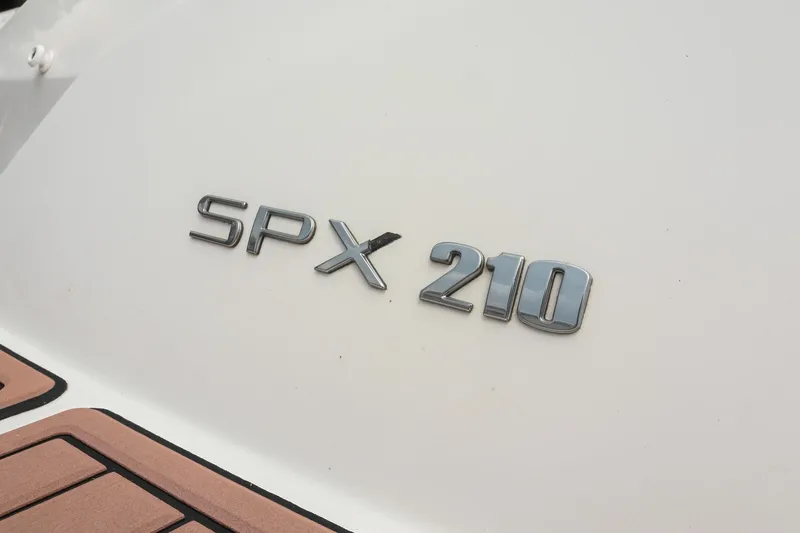 Slide: The Image of 2018 Sea Ray SPX 210 Outboard emblem on white surface. - 6