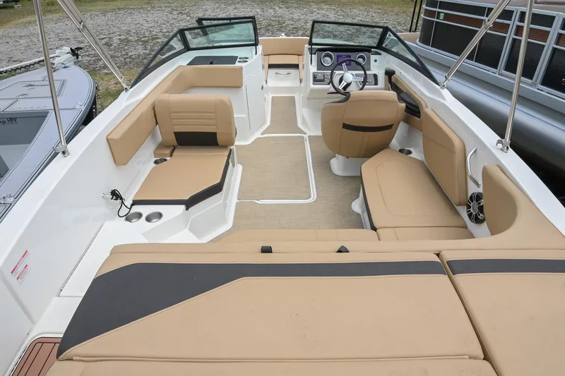Slide: The Image of 2018 Sea Ray SPX 210 Outboard boat interior with tan seating and modern dashboard. - 7