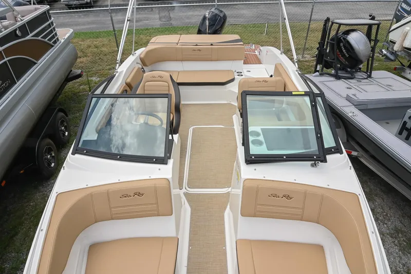 Slide: The Image of 2018 Sea Ray SPX 210 Outboard boat interior with tan seating and open deck layout. - 8