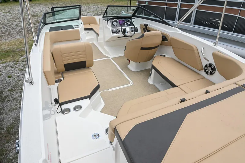 Slide: The Image of 2018 Sea Ray SPX 210 Outboard interior with tan seating and modern dashboard. - 9