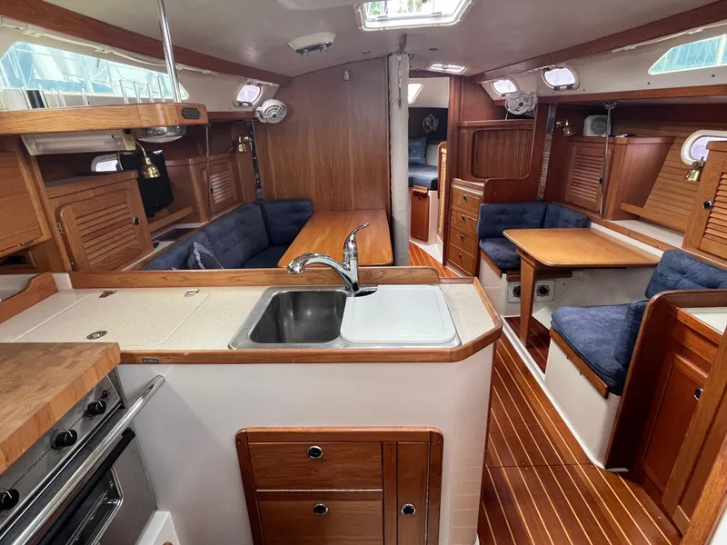 Slide: The Image of Interior of 2000 Catalina 36 Mk II sailboat with wood finish and cozy seating area. - 13