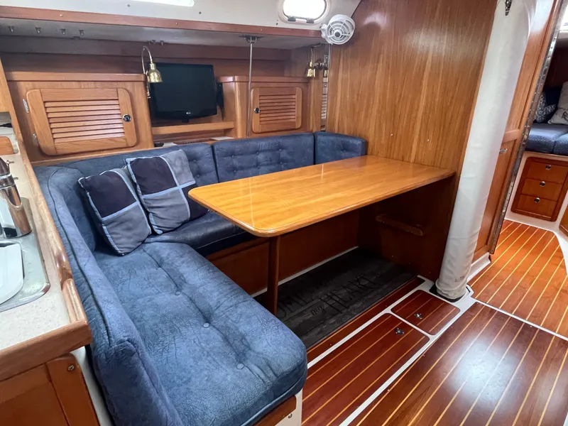 Slide: The Image of Interior of 2000 Catalina 36 Mk II sailboat with cozy seating and wooden table. - 18