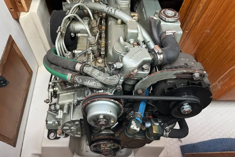 Slide: The Image of Engine of a 2000 Catalina 36 Mk II sailboat, showcasing mechanical components and hoses. - 24