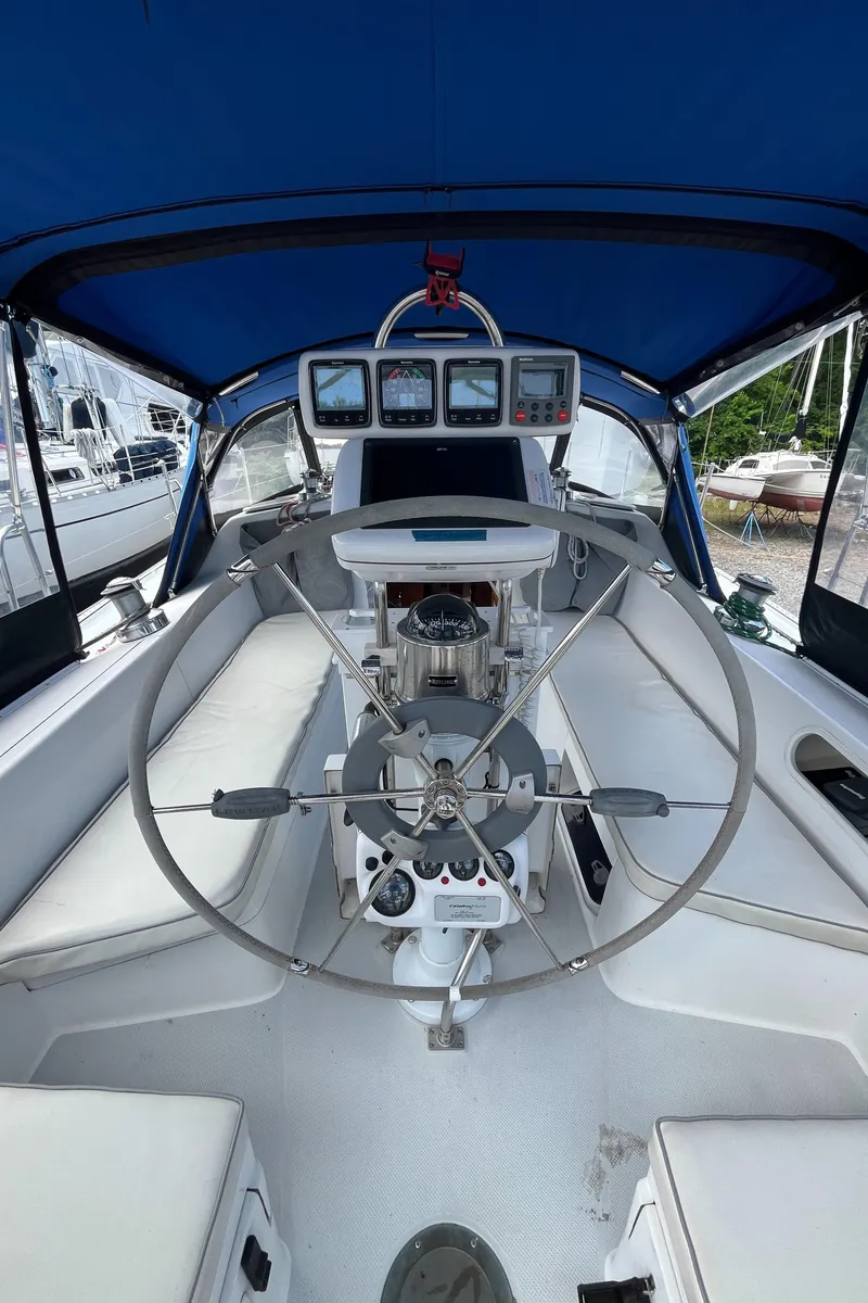 Slide: The Image of Cockpit of 2000 Catalina 36 Mk II sailboat with steering wheel and navigation instruments. - 5