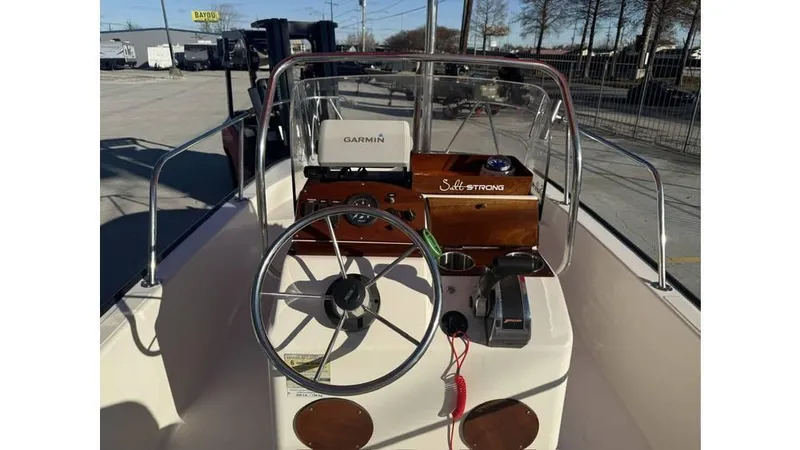 Slide: The Image of 2007 Boston Whaler 150 Montauk boat dashboard with steering wheel and Garmin device. - 5