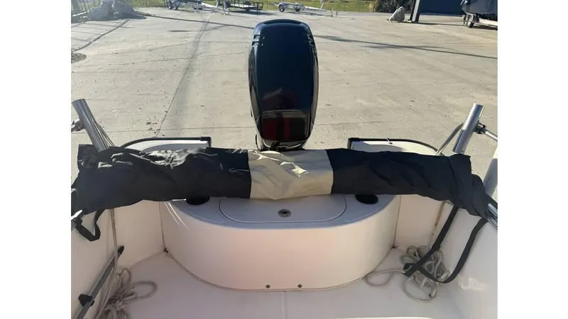 Slide: The Image of 2007 Boston Whaler 150 Montauk boat interior with covered outboard motor. - 8