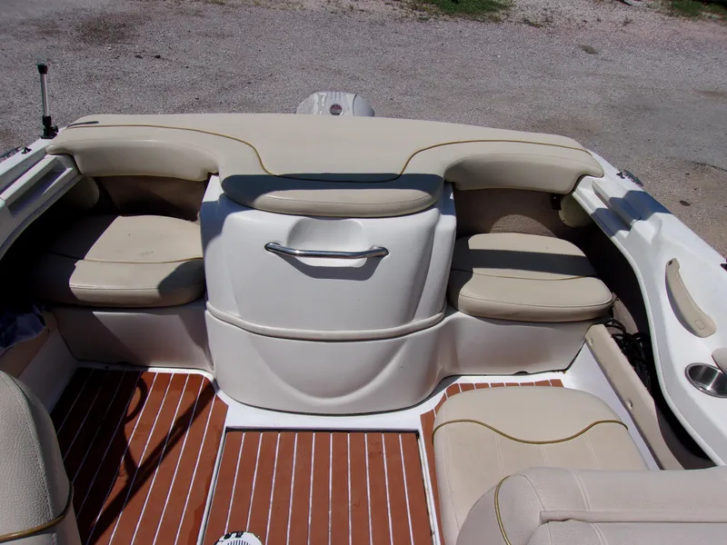 Slide: The Image of Interior view of a 2000 Sea Ray 180 Bow Rider boat with beige seating and wood-patterned flooring. - 10