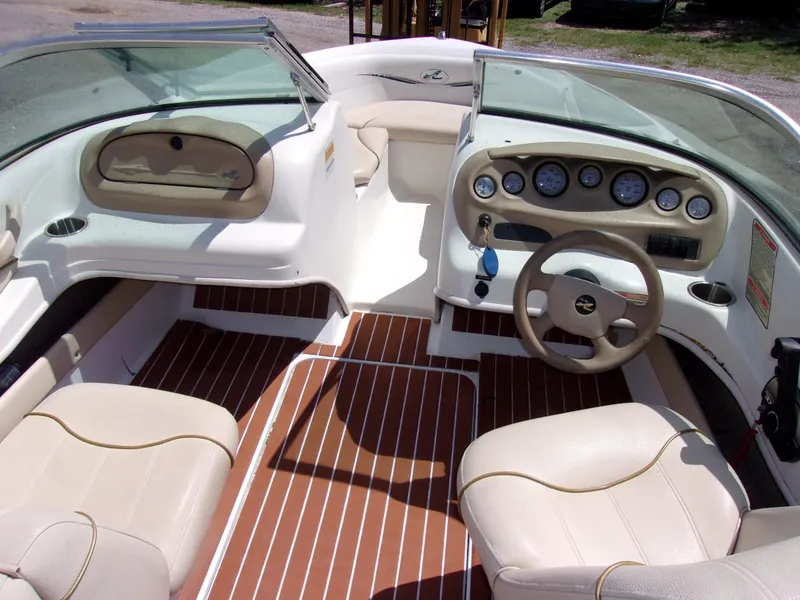 Slide: The Image of Interior of a 2000 Sea Ray 180 Bow Rider boat with beige seating and dashboard. - 5