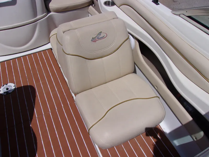 Slide: The Image of 2000 Sea Ray 180 Bow Rider beige seat on striped deck. - 9