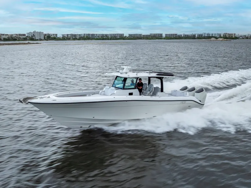 Slide: The Image of 2024 HCB 42 Lujo boat cruising on open water, showcasing sleek design and powerful engines. - 0