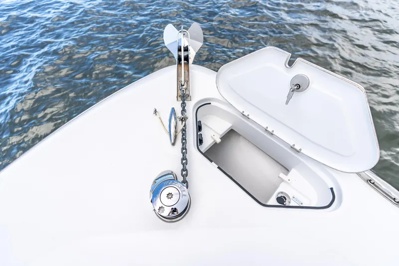 Slide: The Image of 2024 HCB 42 Lujo boat anchor system with open hatch on calm water. - 11