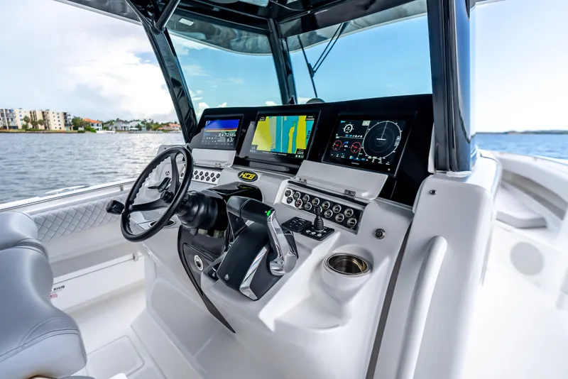 Slide: The Image of 2024 HCB 42 Lujo boat cockpit with advanced navigation displays and controls. - 15
