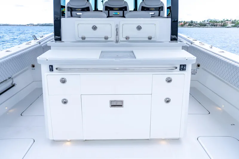 Slide: The Image of 2024 HCB 42 Lujo boat interior with sleek white cabinetry and seating. - 22