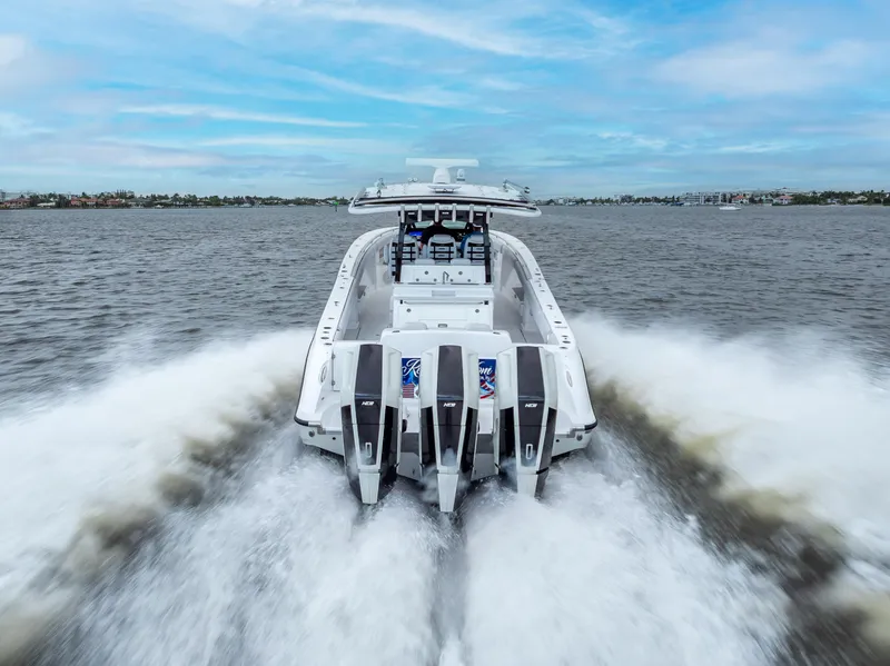 Slide: The Image of 2024 HCB 42 Lujo boat cruising on open water, rear view. - 3