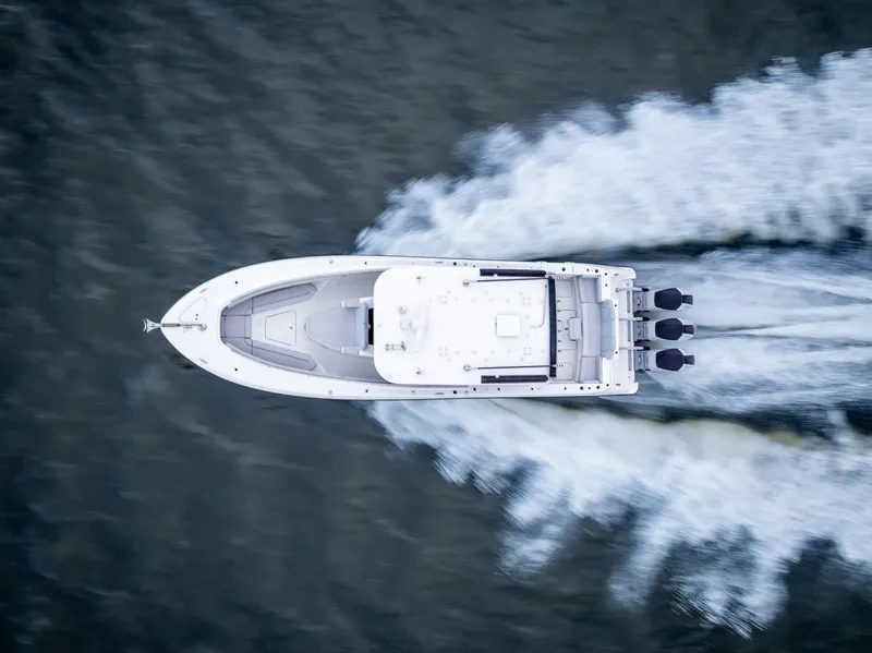 Slide: The Image of Aerial view of 2024 HCB 42 Lujo boat speeding on water. - 4