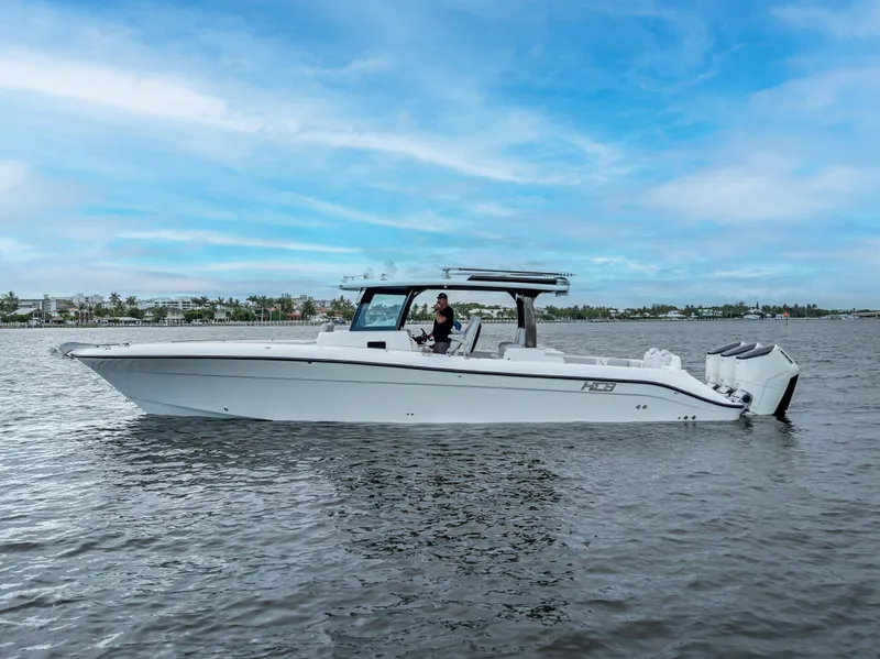 Slide: The Image of 2024 HCB 42 Lujo boat on calm water under a clear blue sky. - 5