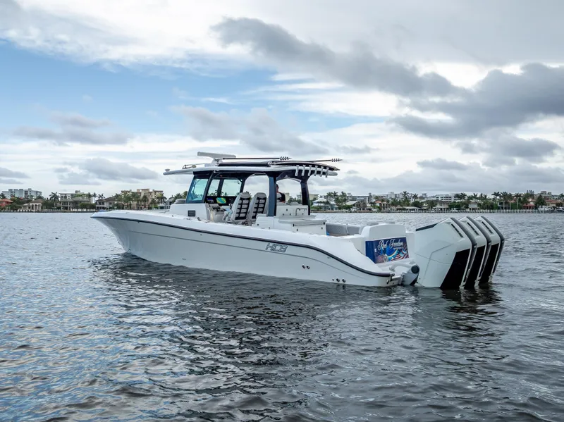 Slide: The Image of 2024 HCB 42 Lujo boat on water, featuring multiple outboard engines. - 6