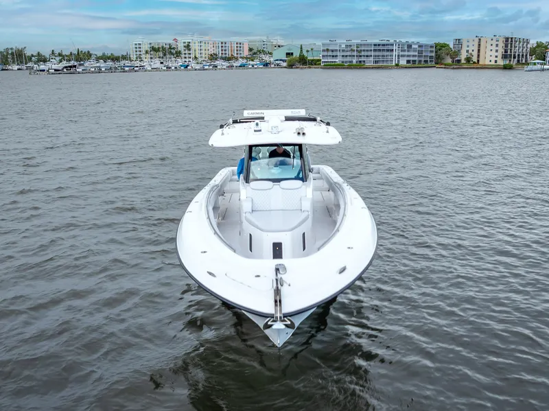 Slide: The Image of 2024 HCB 42 Lujo boat on calm water with cityscape background. - 7
