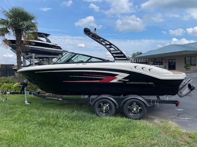 The Image of 2025 Chaparral 21 SSi boat on trailer, parked outdoors near palm tree. - 0