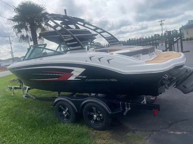 Slide: The Image of 2025 Chaparral 21 SSi boat on trailer, parked outdoors, with overcast sky. - 1
