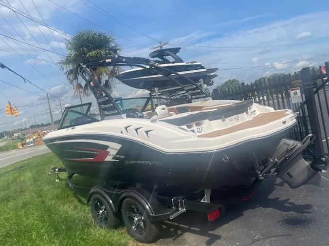 Slide: The Image of 2025 Chaparral 21 SSi boat on trailer, parked near road with palm tree. - 3