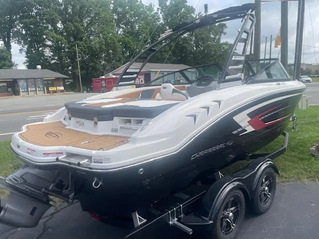 Slide: The Image of 2025 Chaparral 21 SSi boat on trailer, sleek design, parked outdoors. - 4