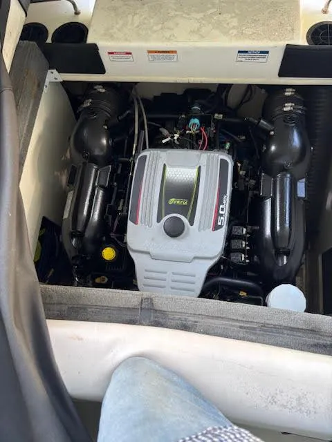 Slide: The Image of Engine compartment of a 2011 Sea Ray 205 Sport boat, featuring a 5.0L MerCruiser engine. - 11