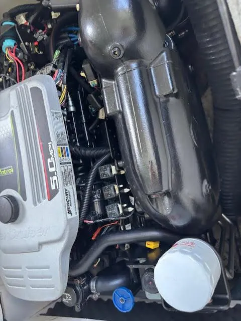 Slide: The Image of Engine of a 2011 Sea Ray 205 Sport boat, featuring a 5.0 MPI motor. - 12