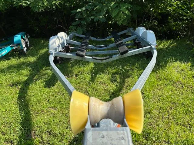 Slide: The Image of Boat trailer for 2011 Sea Ray 205 Sport on grassy area. - 16