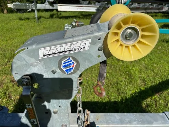 Slide: The Image of Boat trailer winch with yellow roller, labeled "Profile 2000," on grass. - 17