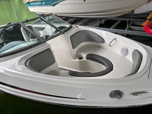 Slide: The Image of 2011 Sea Ray 205 Sport boat with sleek white and gray interior, docked in a marina. - 3