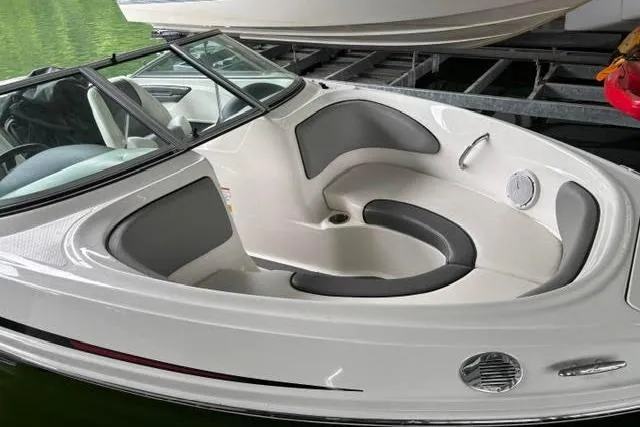 Slide: The Image of 2011 Sea Ray 205 Sport boat with sleek white and gray interior design. - 24