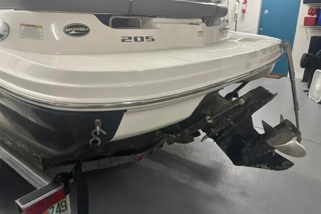 Slide: The Image of Rear view of a 2011 Sea Ray 205 Sport boat in a garage. - 16