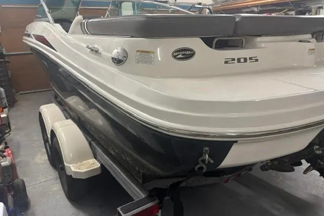 Slide: The Image of 2011 Sea Ray 205 Sport boat on trailer in garage setting. - 19