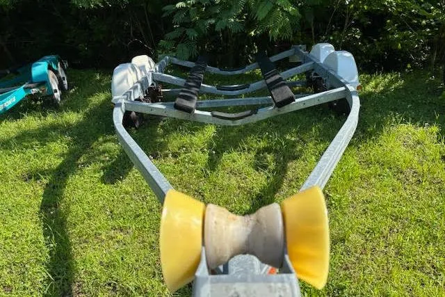 Slide: The Image of Boat trailer for 2011 Sea Ray 205 Sport on grassy area, surrounded by greenery. - 27