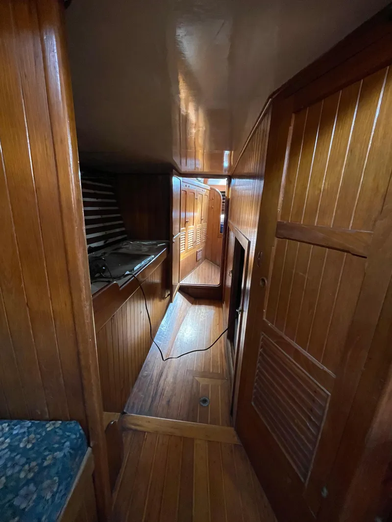 Slide: The Image of 1979 Formosa 46 Cutter interior with wooden paneling and cozy cabin layout. - 12