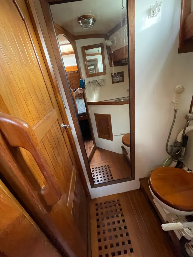 Slide: The Image of 1979 Formosa 46 Cutter yacht bathroom with wooden accents and mirror. - 14
