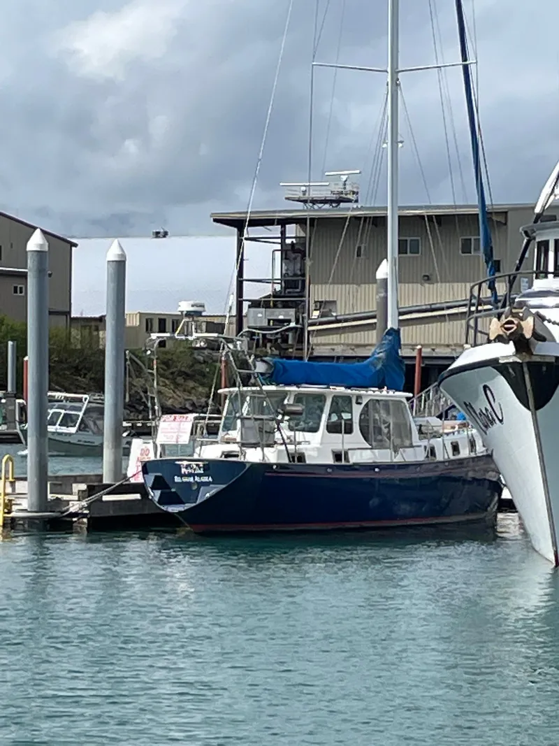 Slide: The Image of 1979 Formosa 46 Cutter sailboat docked in a marina with overcast skies. - 24
