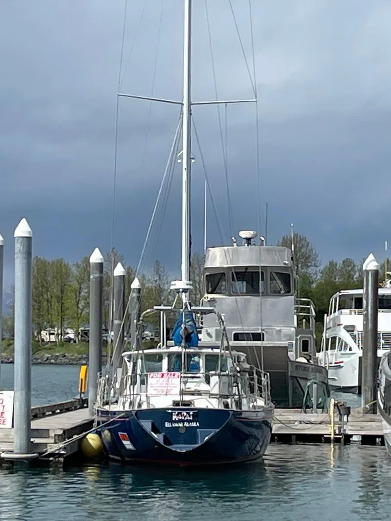 Slide: The Image of 1979 Formosa 46 Cutter docked at a marina under cloudy skies. - 25