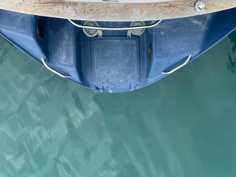 Slide: The Image of Bow of 1979 Formosa 46 Cutter sailboat above turquoise water. - 26