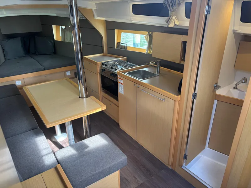 Slide: The Image of Interior of 2015 Beneteau Oceanis 35 sailboat with kitchen, seating, and sleeping area. - 11