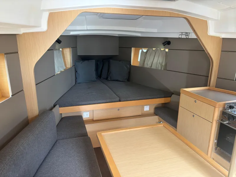 Slide: The Image of Interior of 2015 Beneteau Oceanis 35 sailboat with modern furnishings and cozy seating area. - 13