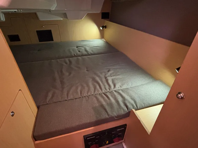 Slide: The Image of Cozy cabin interior of 2015 Beneteau Oceanis 35 sailboat with cushioned bed. - 14