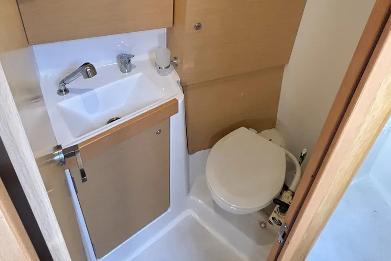 Slide: The Image of Compact bathroom in 2015 Beneteau Oceanis 35 sailboat with sink and toilet. - 15
