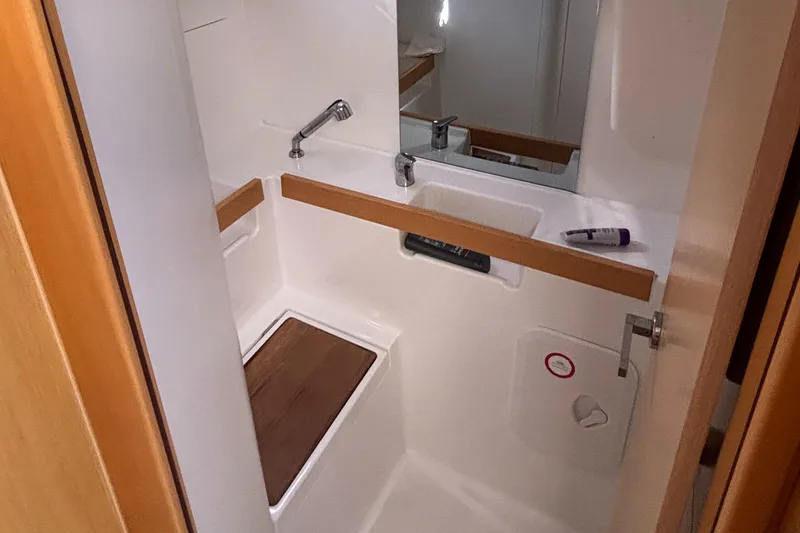 Slide: The Image of Compact bathroom in a 2015 Beneteau Oceanis 35 sailboat, featuring a sink and mirror. - 16